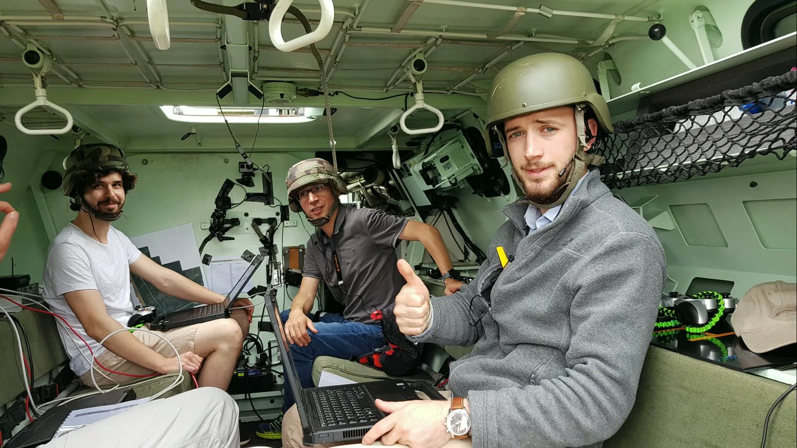 Jules and two colleagues sitting in a French Army armored vehicle during the CoHoMa challenge.