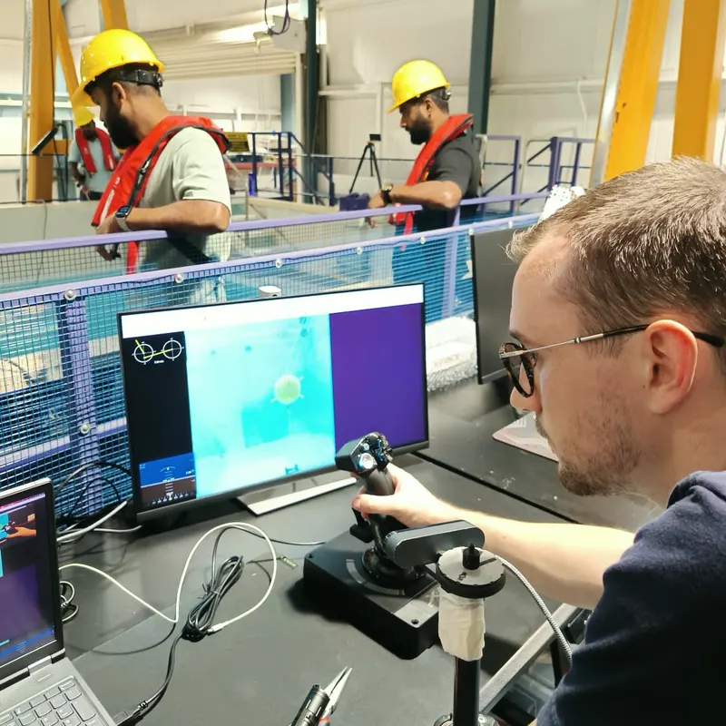 Over-the-shoulder view of Jules remotely controlling the X301 AUV while preparing it for a three-day mission at sea.